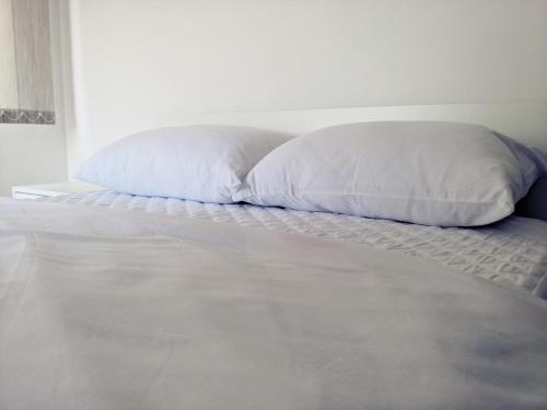 a white pillow sitting on top of a bed at Lux Studio Apartment Vidanovic in Pirot