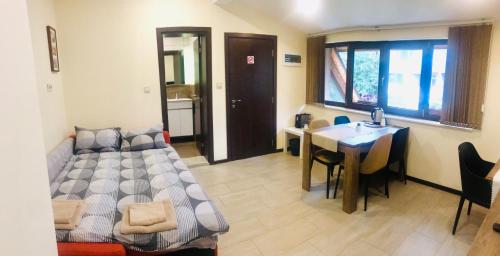 a room with a bed and a table and a kitchen at Sofia Family House - Free Parking in Sofia