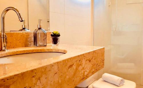 a bathroom with a sink and a toilet and a shower at STUDIOS 195 - Gramado in Gramado