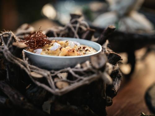 a bowl of food sitting on top of a table at Nobelos Seaside Lodge in Agios Nikolaos