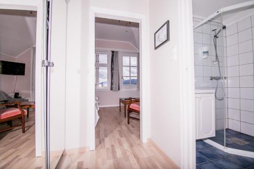 a bathroom with a shower and a glass door at Kringsjå Hotel in Balestrand