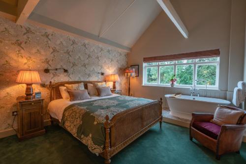 a bedroom with a bed and a bath tub and a sink at Albero Bedrooms in Bedford