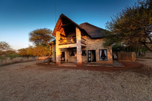 an old brick house on a gravel road at Makhato Bush Lodge 111 in Bela-Bela