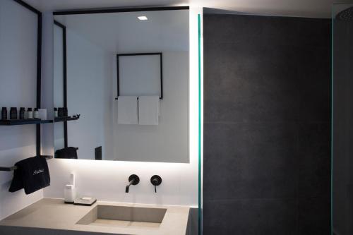 a bathroom with a shower with a sink at The Alex Monte Kastella, Santikos Collection in Piraeus
