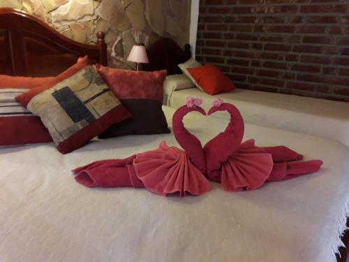 a bed with a heart made out of red sheets at Estancia Santa Leocadia in Bialet Massé
