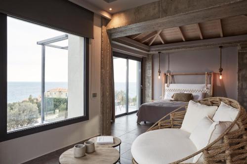 a bedroom with a bed and a large window at Villa Sea front in Skala
