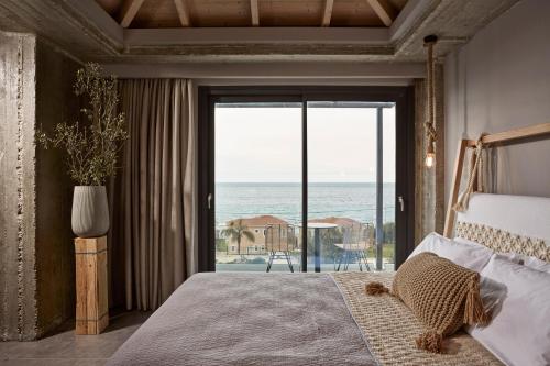 a bedroom with a bed and a view of the ocean at Villa Sea front in Skala