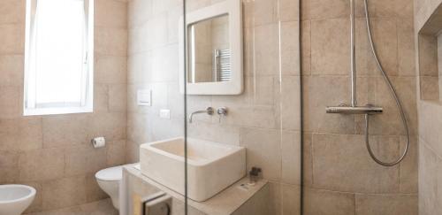 a bathroom with a shower and a toilet and a sink at Bed & Breakfast AMATI in Fasano