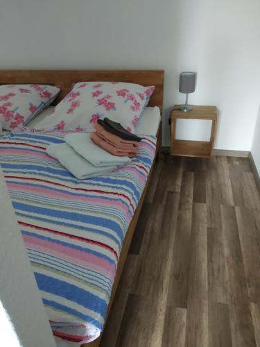 a bed in a bedroom with a wooden floor at Brockenblick in Altenau