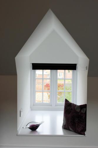 a white room with a window and a pillow at Kings Head Hotel in North Elmham