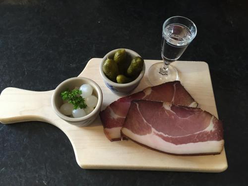 a plate of meat and vegetables and a glass of wine at Wein Lodge Durbach - Josephsberg 2 in Durbach