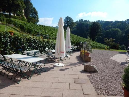 a group of tables and chairs with umbrellas at Wein Lodge Durbach - Josephsberg 2 in Durbach