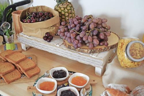 a table topped with a tray of grapes and bread at Antico Borgo dei Templi in Agrigento