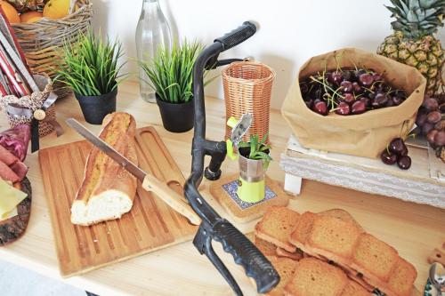 a table topped with bread and a knife and a cutting board at Antico Borgo dei Templi in Agrigento