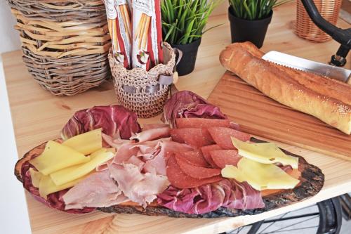 a plate of meats and cheese on a table at Antico Borgo dei Templi in Agrigento