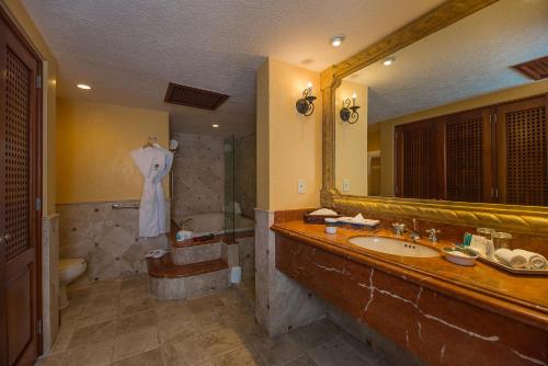 a bathroom with a sink and a mirror at The Ridge at Playa Grande in Cabo San Lucas