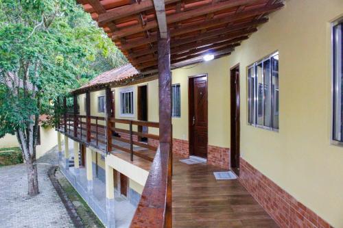 a porch of a house with a wooden deck at Pousada Doce Mel in Penedo