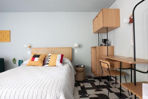 a bedroom with a bed and a desk and a table at Casa Ixaya by Barrio México in Guadalajara