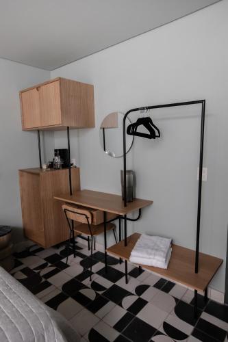 a bedroom with a desk and a lamp and a bed at Casa Ixaya by Barrio México in Guadalajara