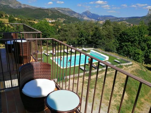 a balcony with a view of a pool and mountains at Hôtel le Panoramic - Votre Hôtel au cœur des Gorges du Verdon in La Palud sur Verdon