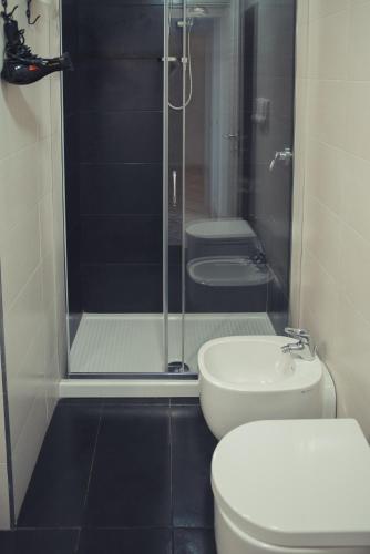a bathroom with a shower and a toilet and a sink at B&B Sweet Sleep in Naples