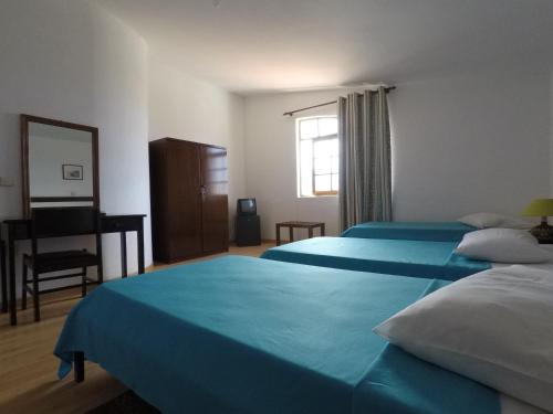 Katil atau katil-katil dalam bilik di Bed and breakfast Residencial Maravilha
