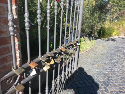 a fence with locks on the side of a house at Hotel Alte Straßenmeisterei in Eutin