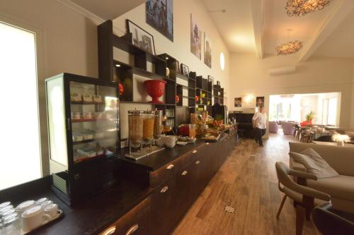 a store with a long counter in a room at Hôtel Villa Sophia - ADULTS ONLY JULY AND AUGUST in Mougins
