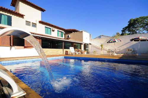 een zwembad met een fontein voor een huis bij Pousada Brisas de Búzios in Búzios