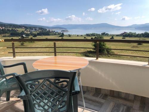 a table and chairs on a balcony with a view at VILLA RELAX in Tsigov Chark
