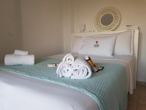 a bedroom with a bed with towels on it at Cozy Cliff House in Nea Potidaea