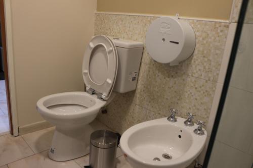 a bathroom with a toilet and a sink at Eclat Suites Hotel Boutique in Villa Mercedes