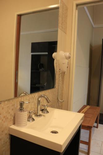 a bathroom with a sink and a mirror at Eclat Suites Hotel Boutique in Villa Mercedes