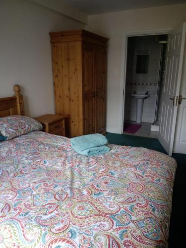 a bedroom with a bed with a colorful blanket on it at 37 Atlantic Point, Ground Floor, Sea View Apartment sleeps 6 in Bundoran