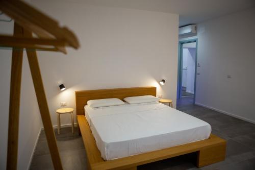 Ένα ή περισσότερα κρεβάτια σε δωμάτιο στο La Casetta - Rooms & Garden