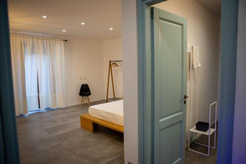 a bedroom with a bed and a window at La Casetta - Rooms & Garden in San Ferdinando