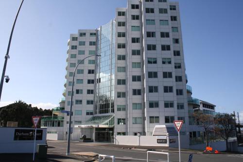 a tall white building with a street light in front of it at Kingsview CBD Tauranga in Tauranga