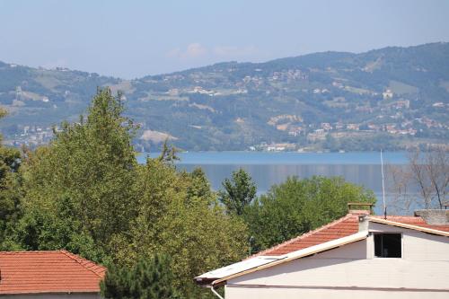 a house with a view of a lake and mountains at Hotel Ipekyolu in Sapanca