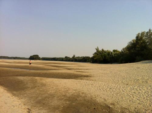 a person standing in the middle of a beach at kuća za odmor Vesna četiri zvjezdice in Opatovac