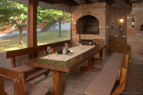 a dining room with a table and an outdoor oven at kuća za odmor Vesna četiri zvjezdice in Opatovac