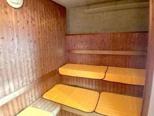 a small sauna with two beds in it at Hotel Shibukawa Hills in Shibukawa