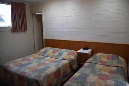 a room with two beds and a window at Big River Motel in Echuca