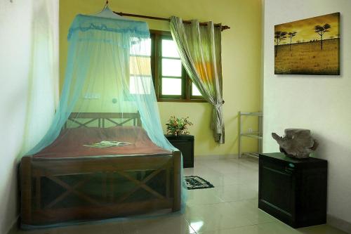 a bedroom with a wooden bed in a room at Dream House in Hikkaduwa