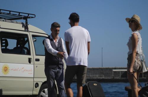 a group of three men standing next to a van at Hotel Il Girasole in Anacapri