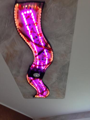a purple lighted letter k on a wall at Gaestehaus Klaus in Mendig