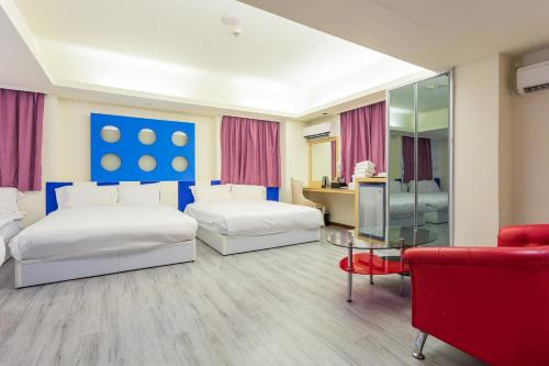Postel nebo postele na pokoji v ubytování Newrise Hotel