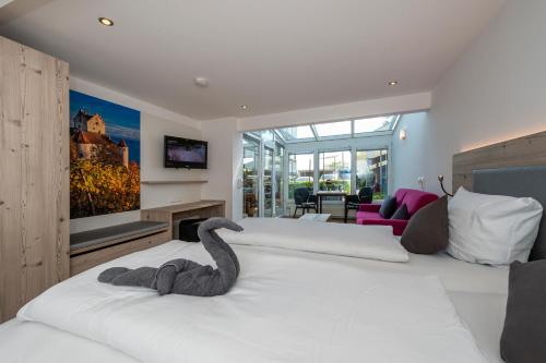 a bedroom with a bed with a stuffed elephant on it at Gästehaus Holzer in Konstanz