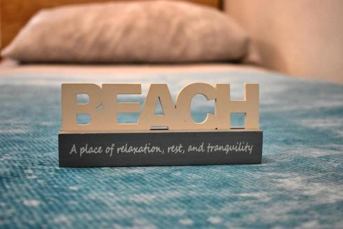a wooden sign on top of a bed at Apartment Hajdi in Podstrana