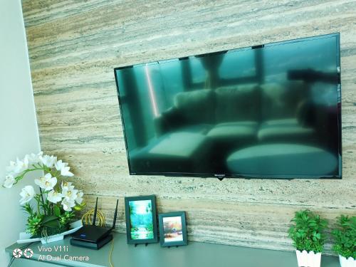 a flat screen tv hanging on a wall at Evo Bangi Duplex Homestay D' Imahzzz - 3BR or 2BR in Bangi