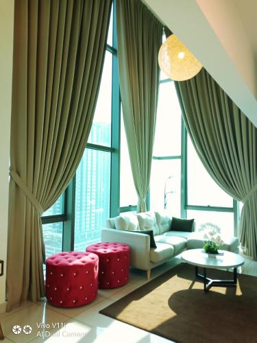 a living room with a couch and a large window at Evo Bangi Duplex Homestay D' Imahzzz - 3BR or 2BR in Bangi